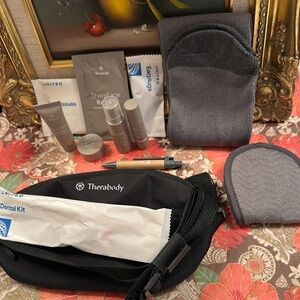 Therabody Black Fanny pack full of accessories United Business Class Travel Kit